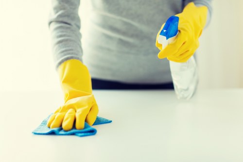 Cleaning team sanitising desks and shared office surfaces in Pimlico